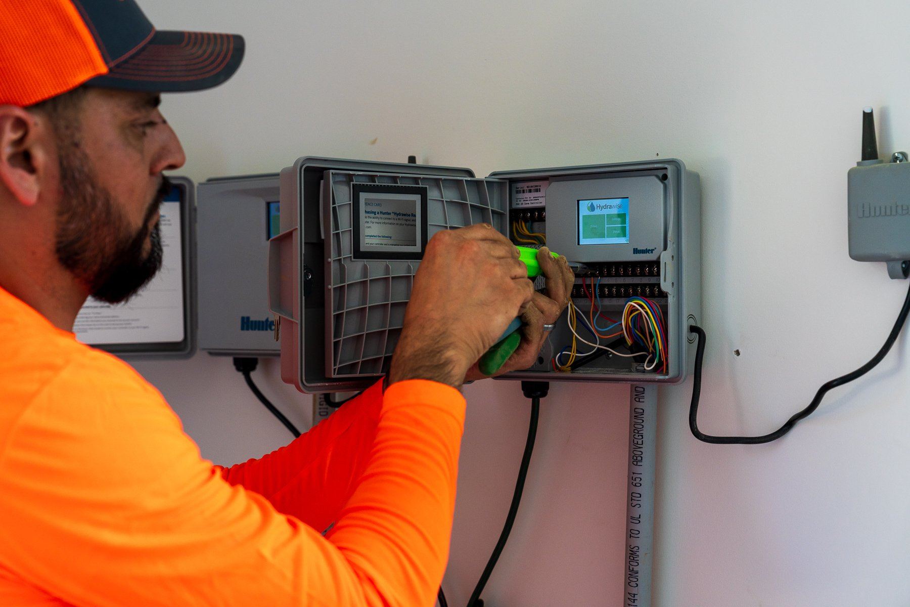 Technician wiring a smart irrigation controller