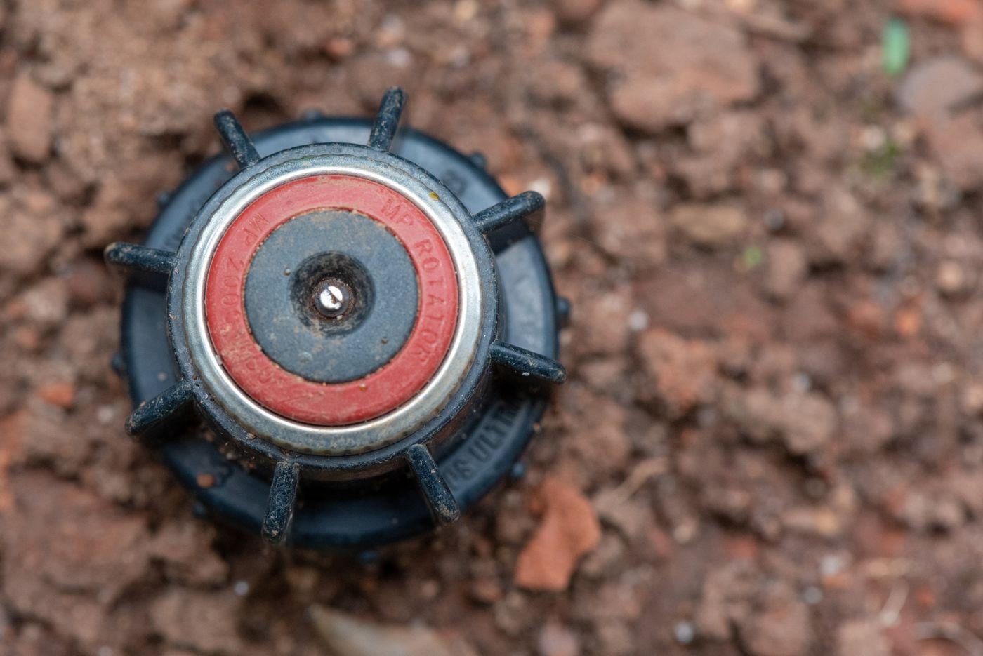 New sprinkler head set in bare soil